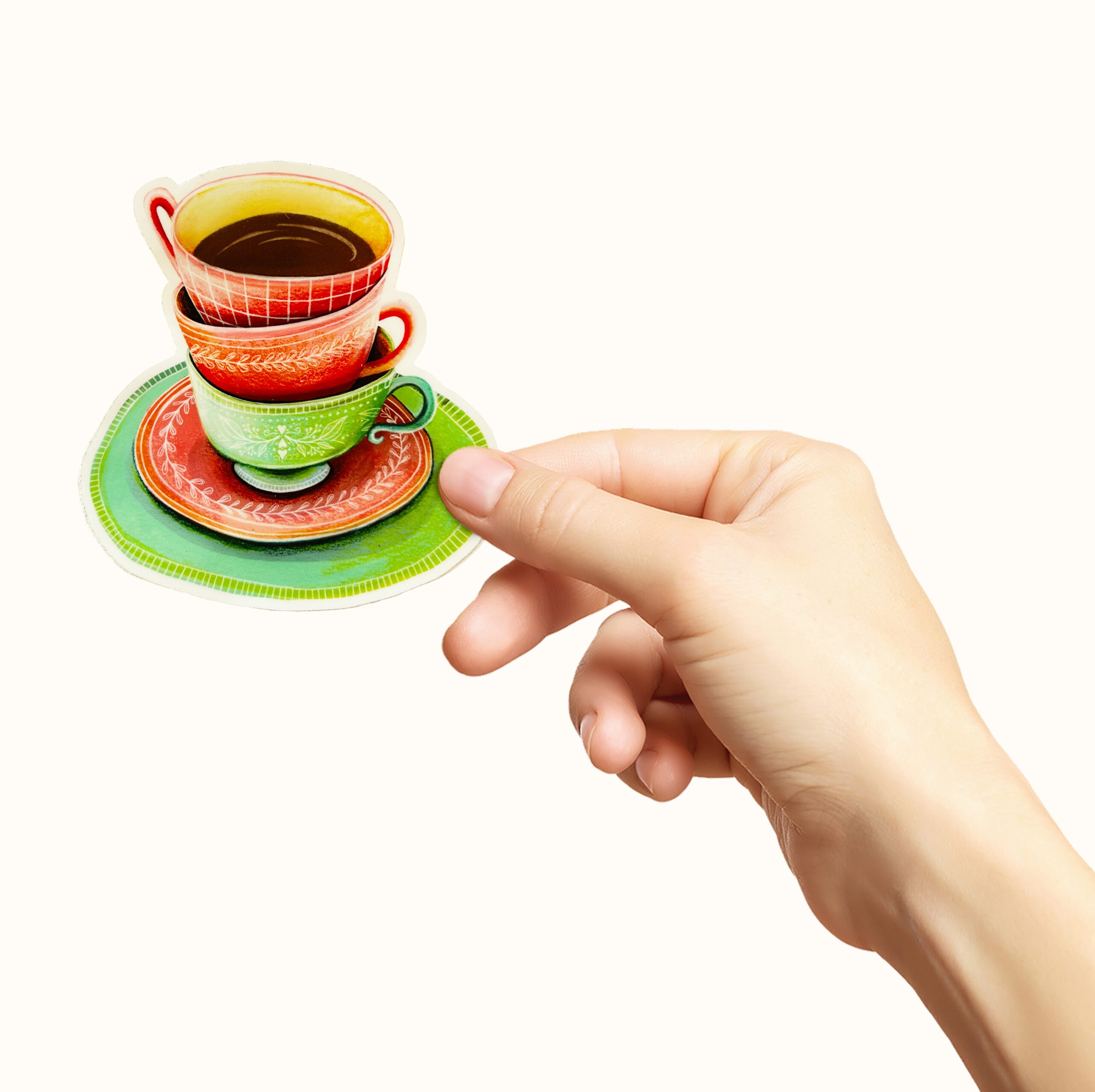 Hånd som holder et klistremerke med kopper