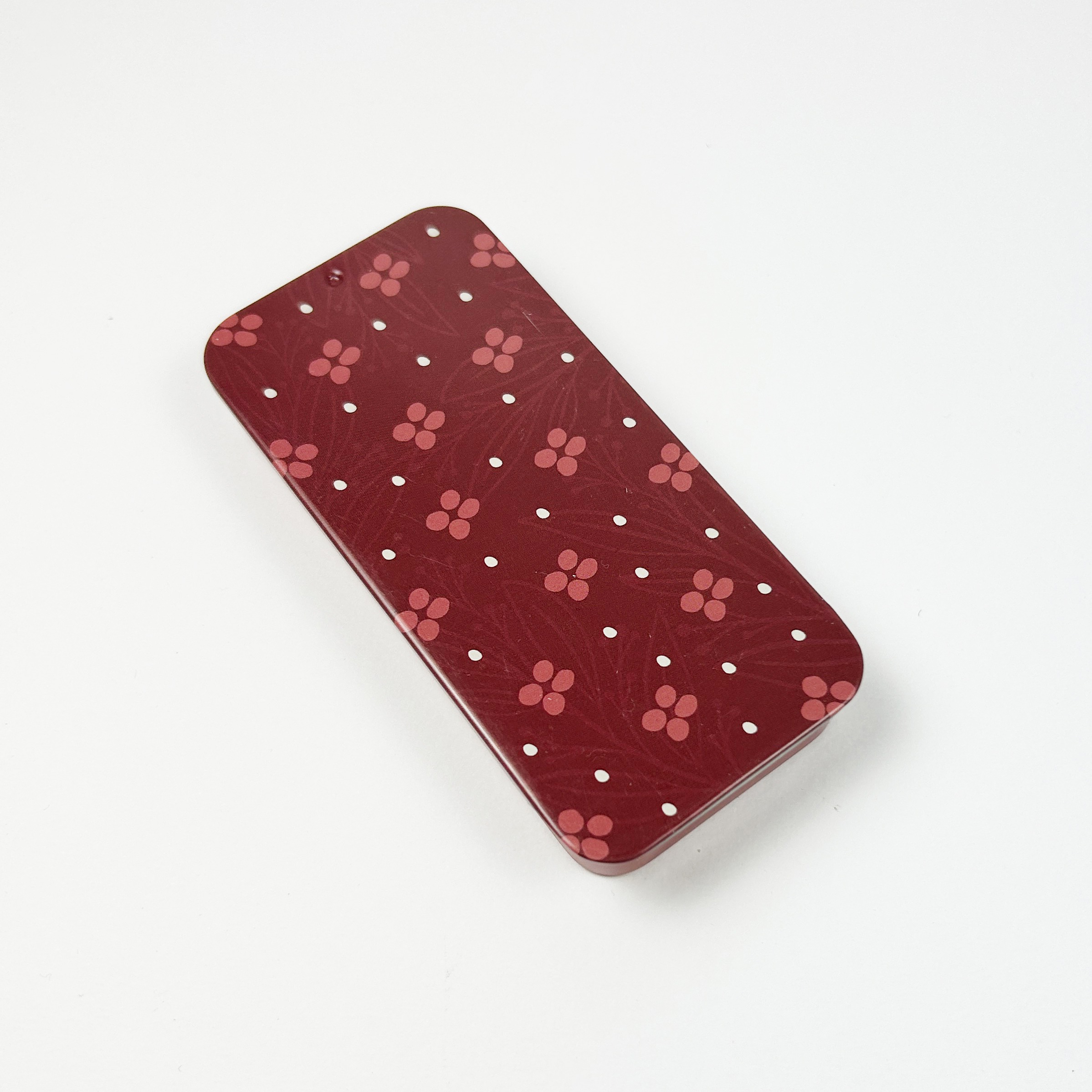 Elegant metallboks med småblomstrete mønster i rosa og burgunder