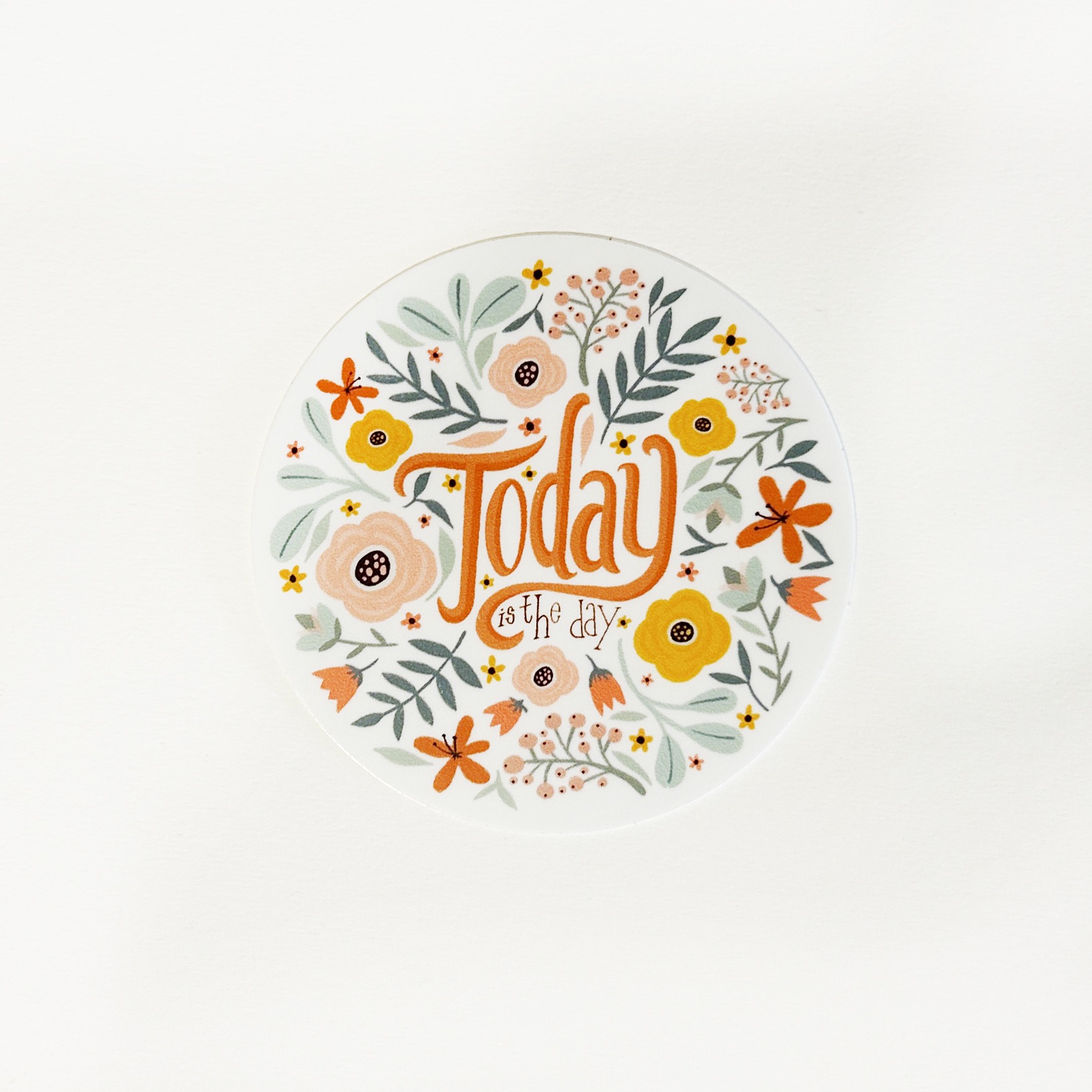 klistremerke med blomster og teksten today is the day
