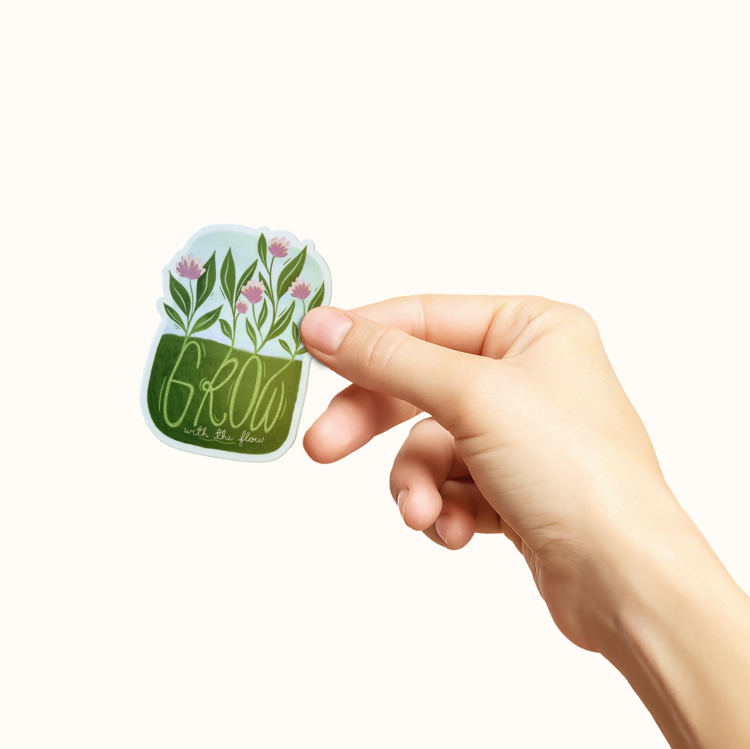 Klistremerke med teksten "grow with the flow"