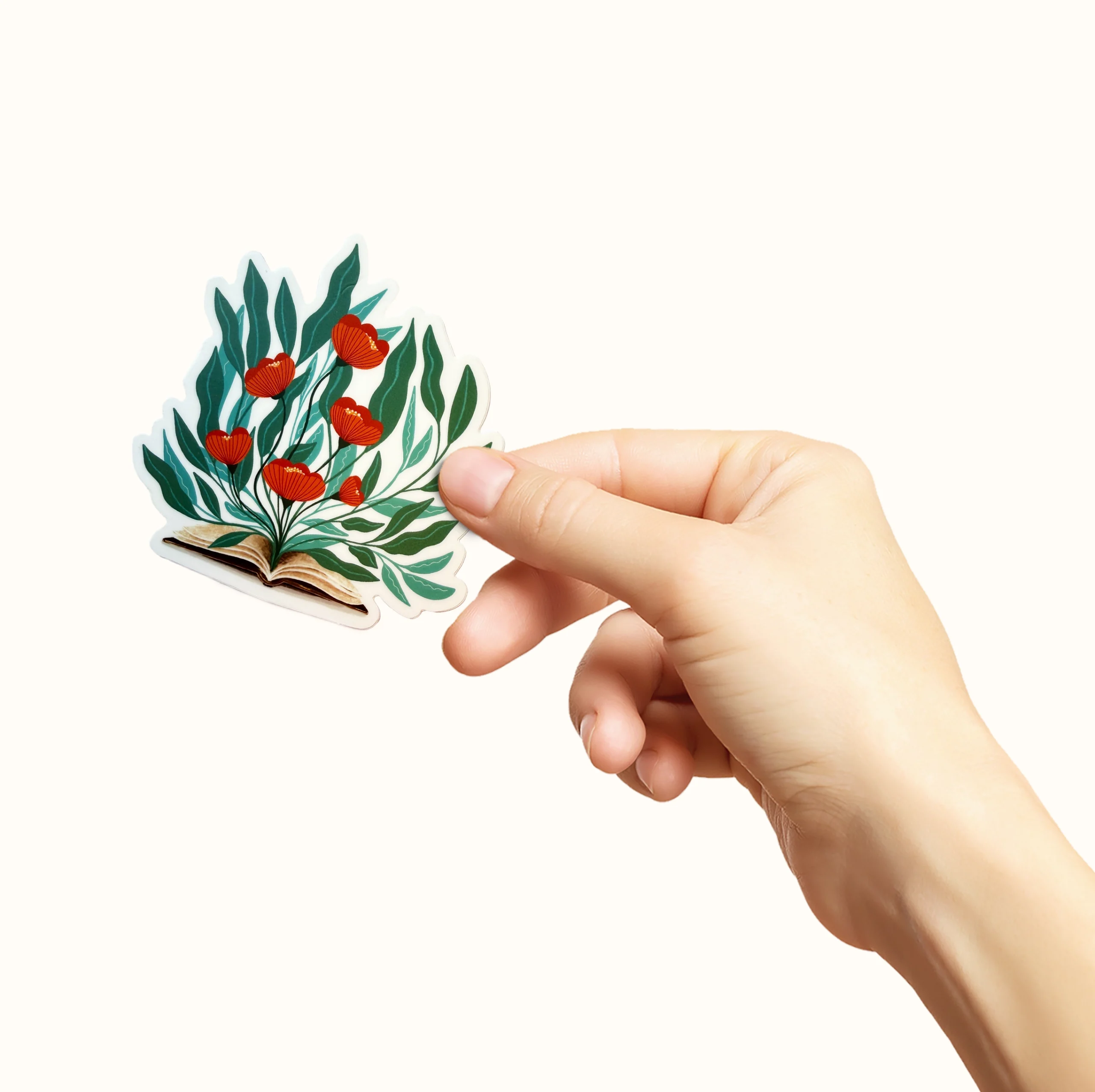 Klistremerke med en åpen bok det kommer masse blomster ut av