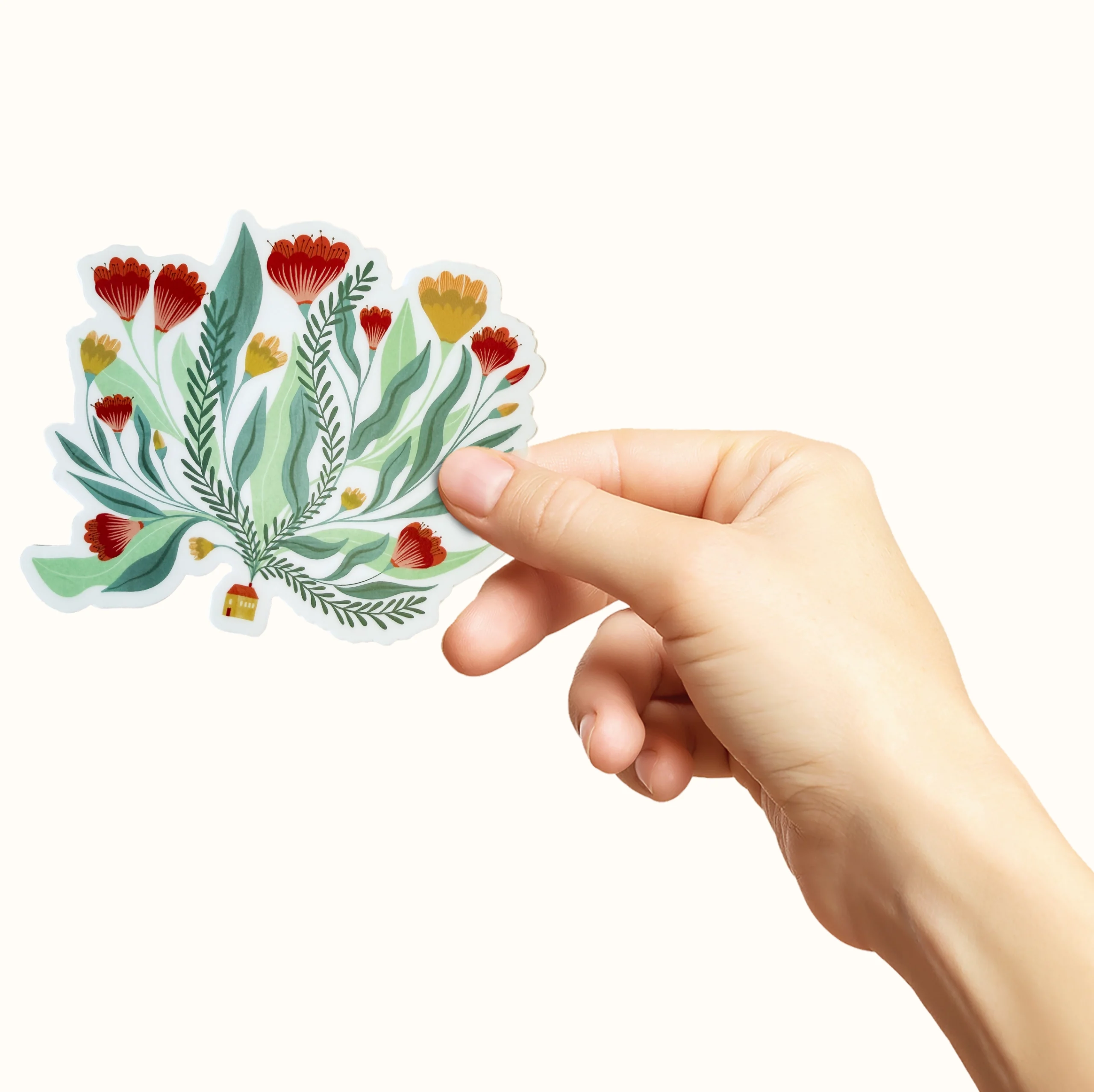 Klistremerke med et hus hvor det kommer mange blomster ut av pipa