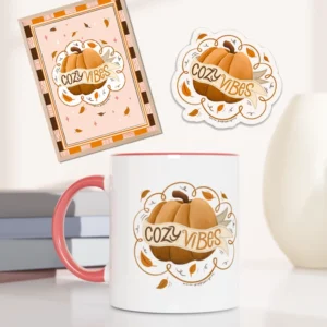 Pakke med kopp, klistremerke og kumstprint med høstmotiv